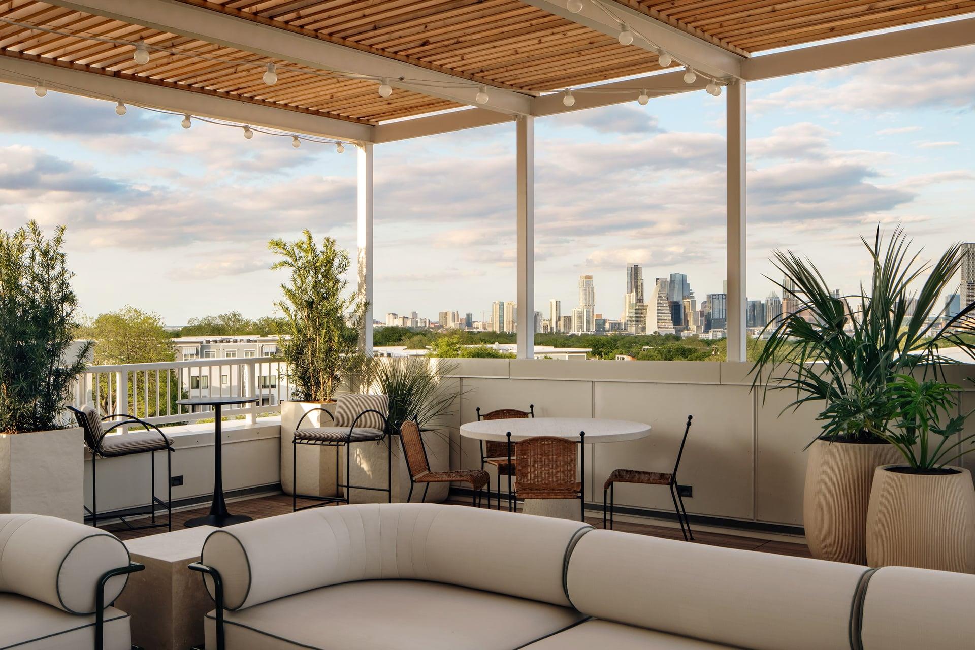 An inviting covered terrace frames dynamic skylin