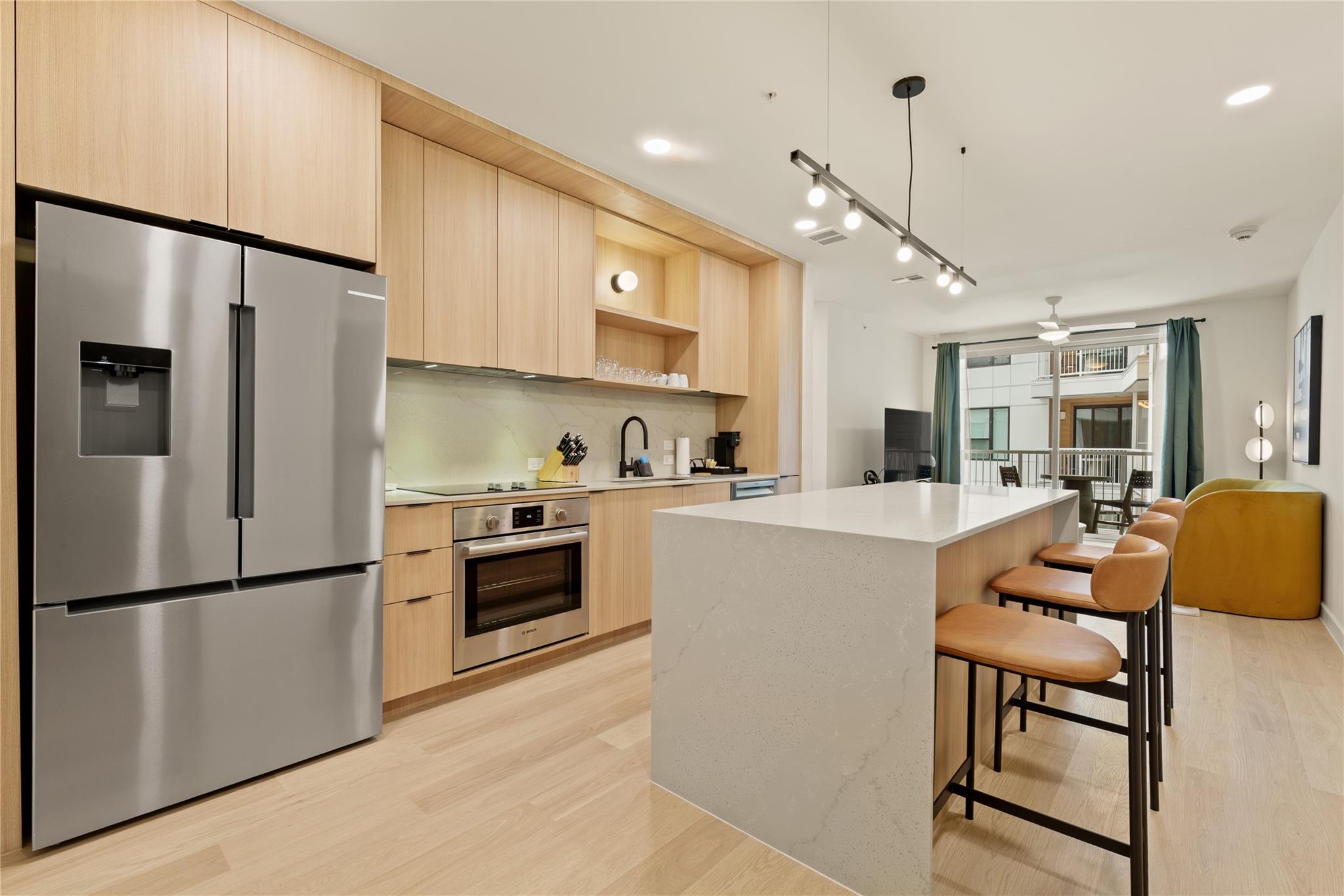 Sleek modern cabinetry and a waterfall-edge islan