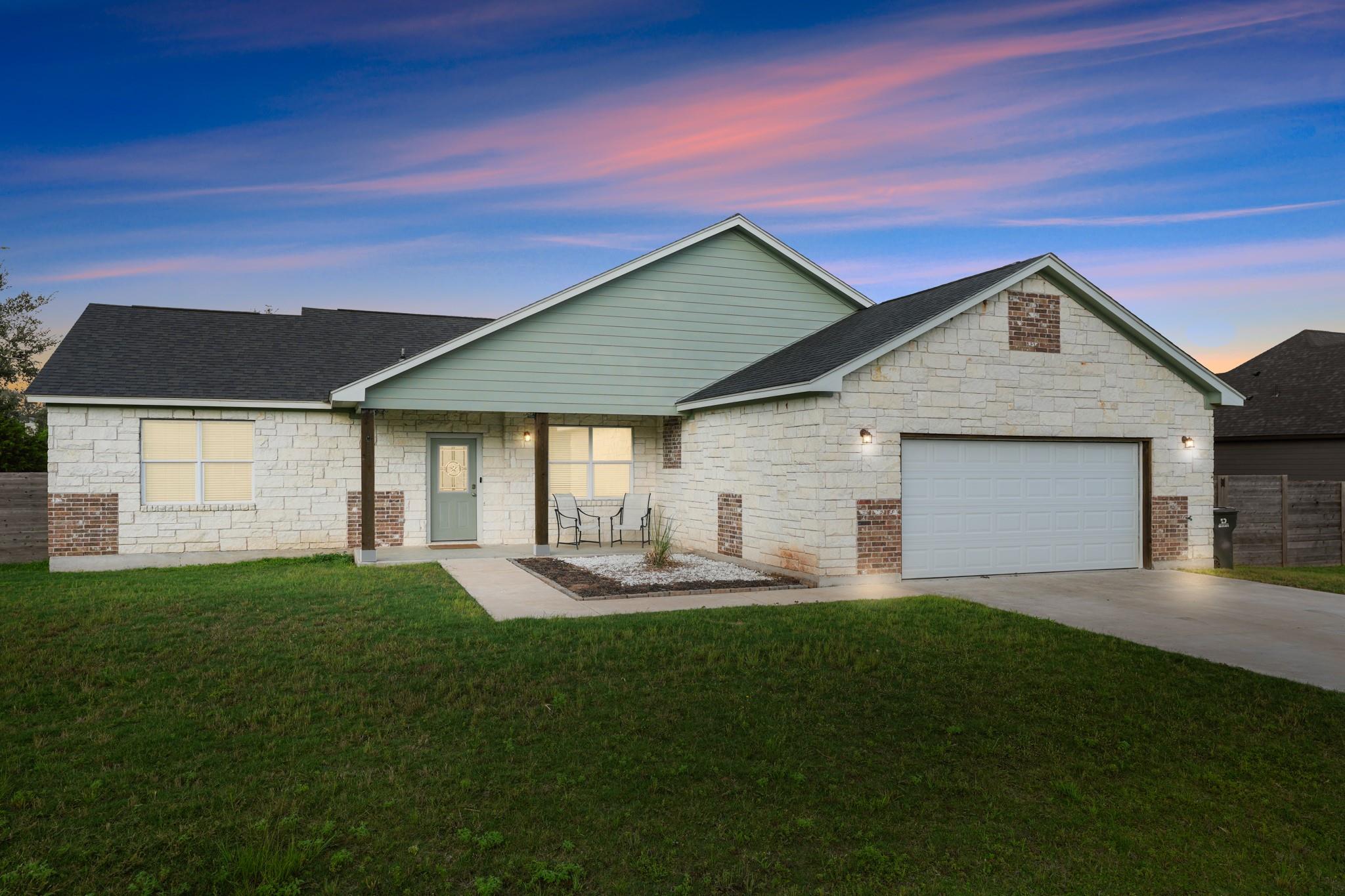 A classic stone exterior, covered entry, and neat