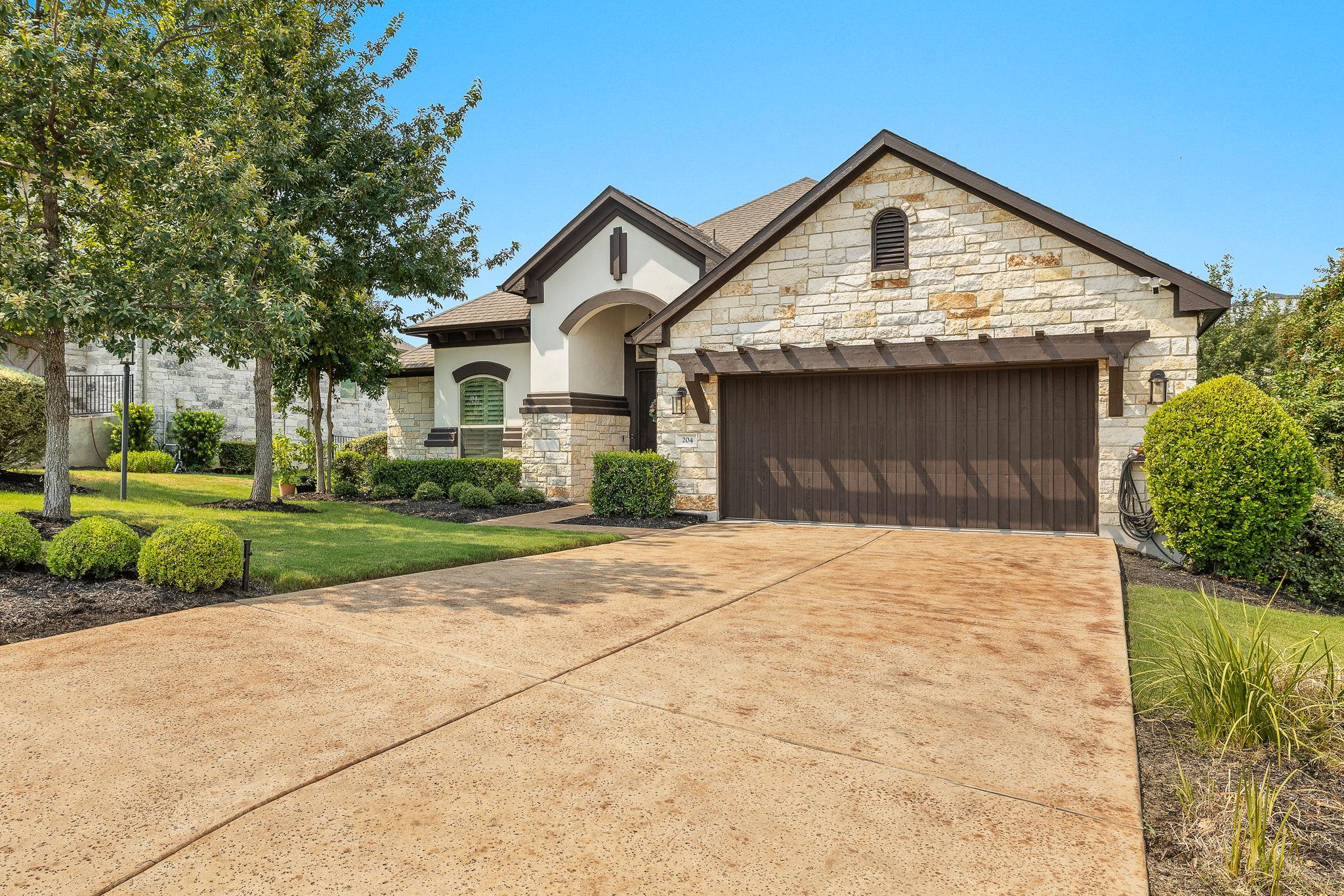 An inviting stone facade accents the front of thi