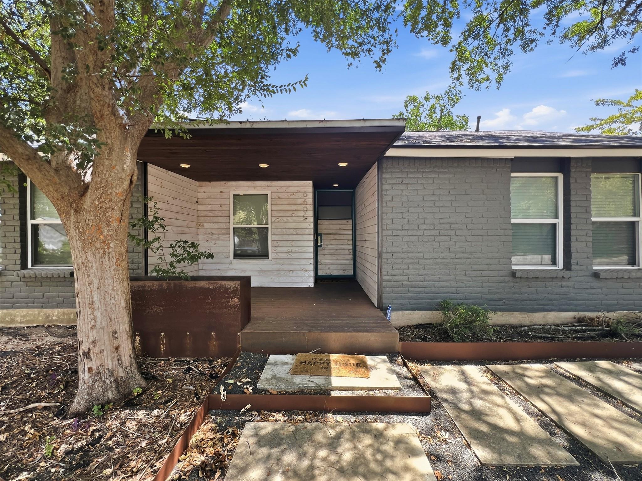 A welcoming front porch with mixed wood and paint