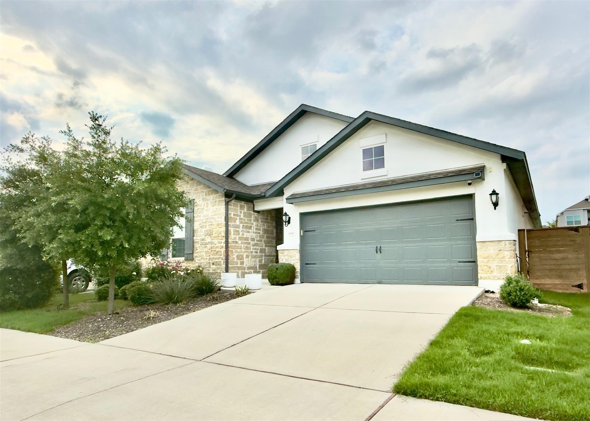An inviting stone and stucco exterior features a 