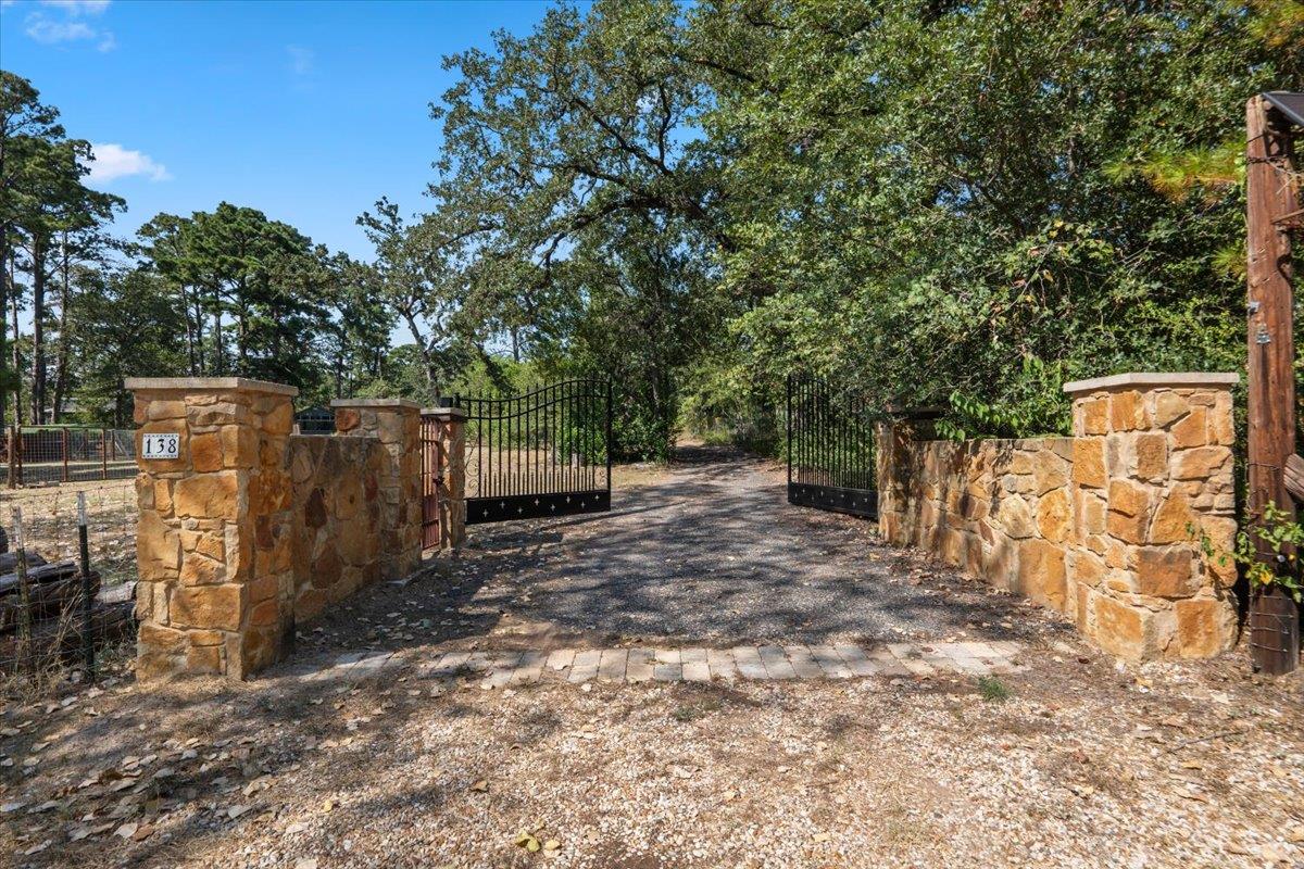 Stone pillars and secure wrought iron gates frame