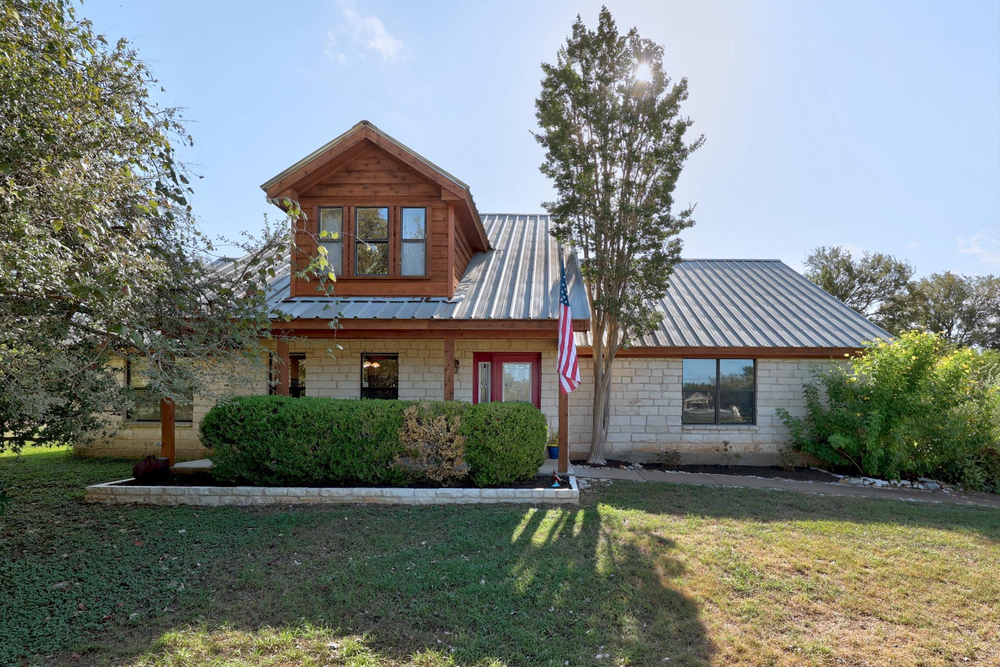 Natural stone and warm wood siding complement the