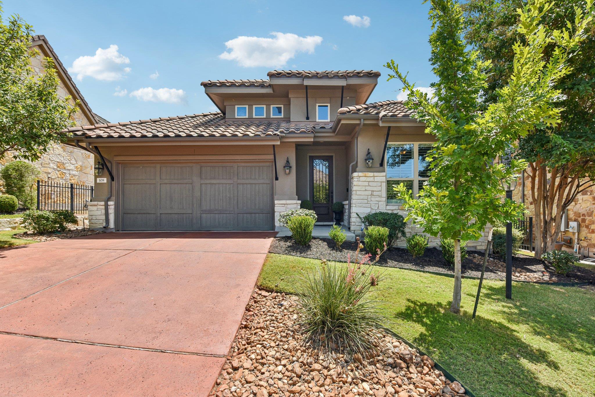 Spanish tile roofing and stone accents define the