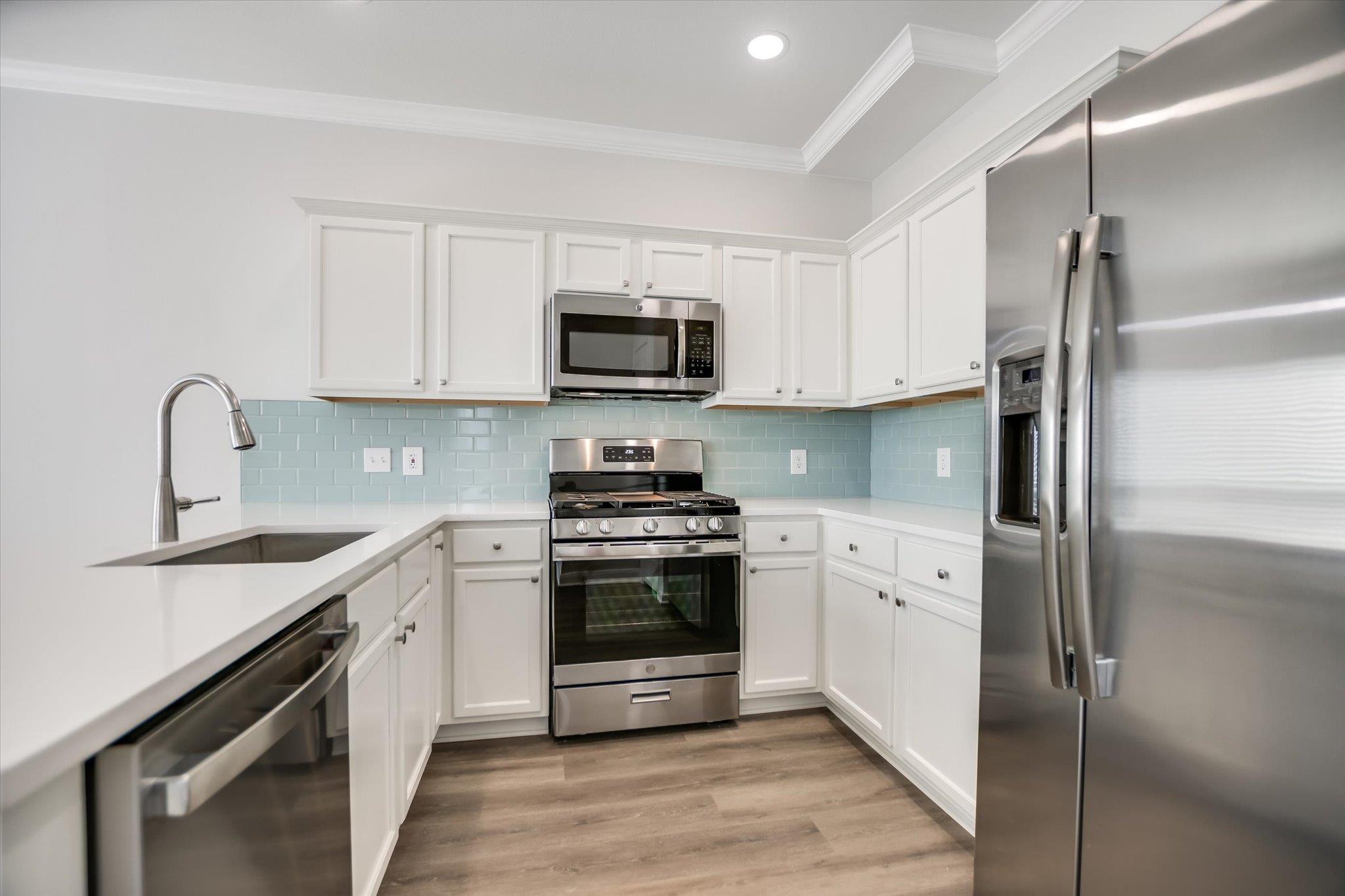 Sleek countertops and modern stainless steel appl