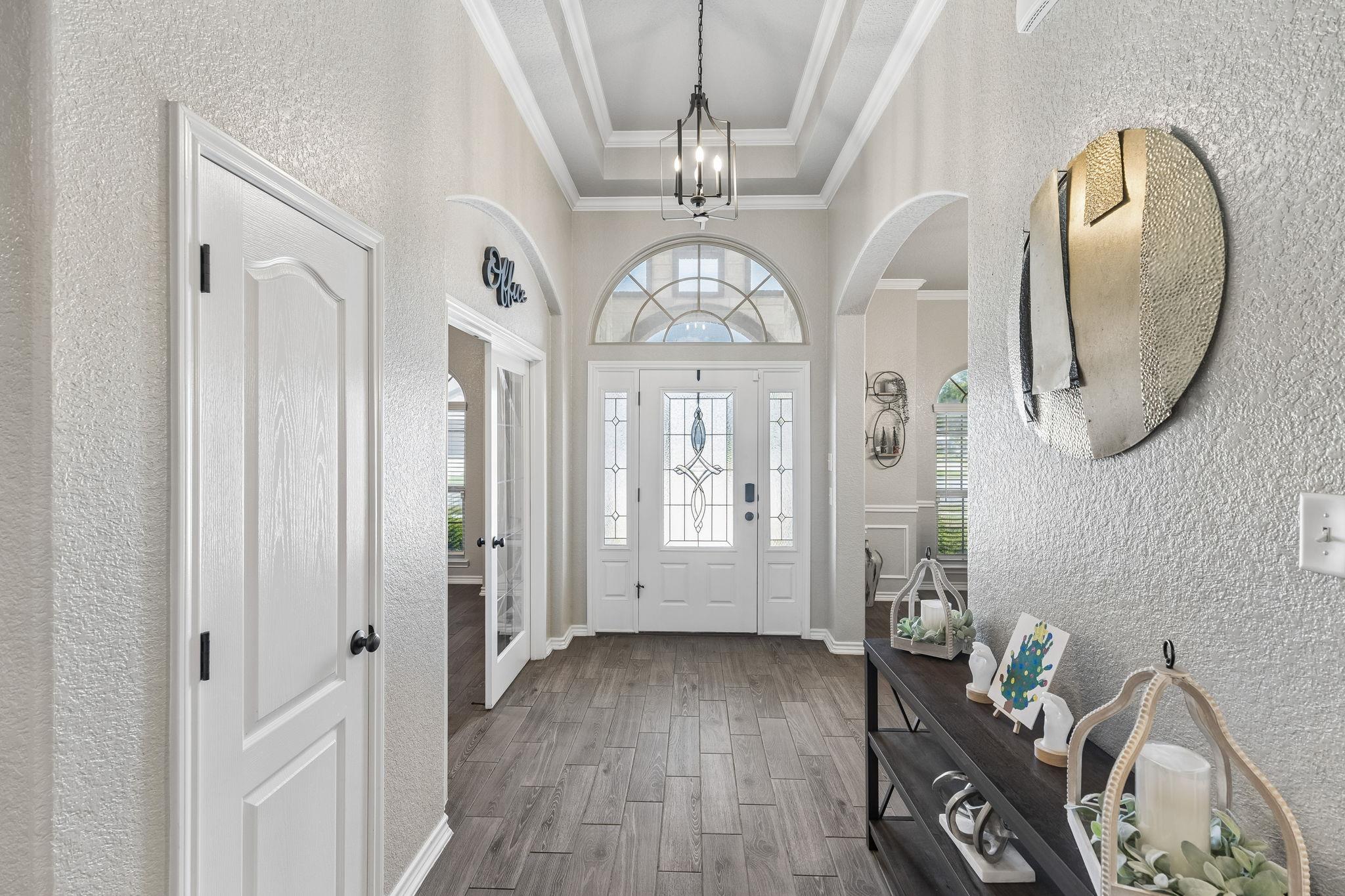 Elegant textured walls and wood-look tile floorin