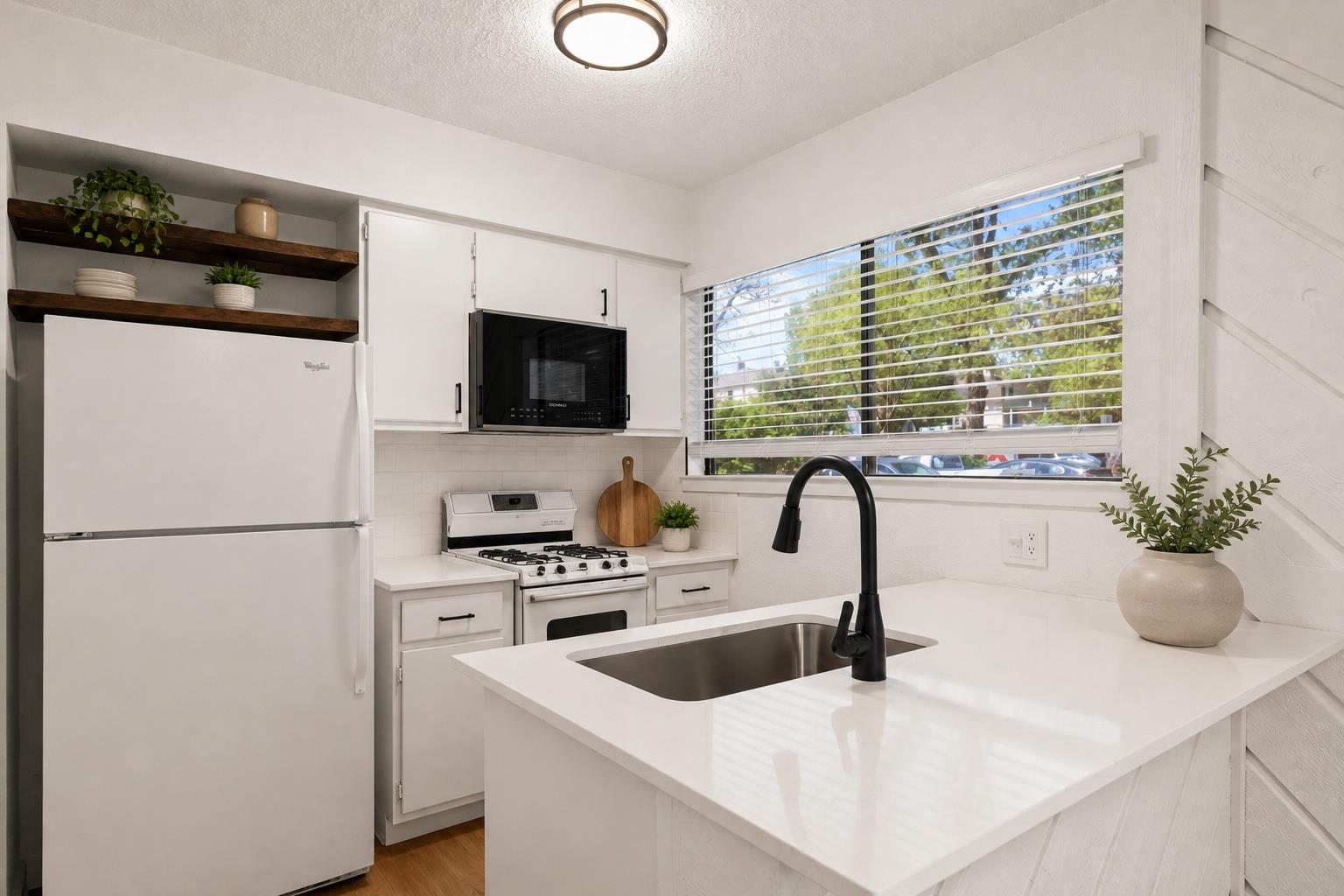 Gleaming stone countertops and open shelving maxi