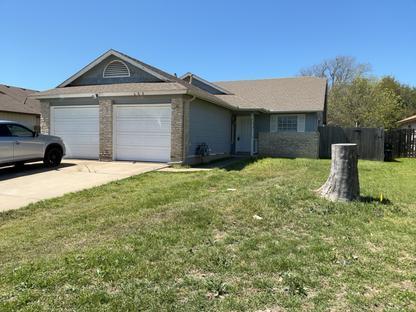 A classic single-story brick and siding home feat