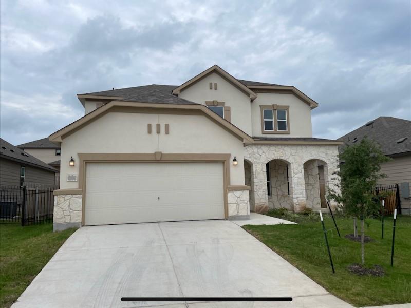 Textured stucco and natural stone detailing accen