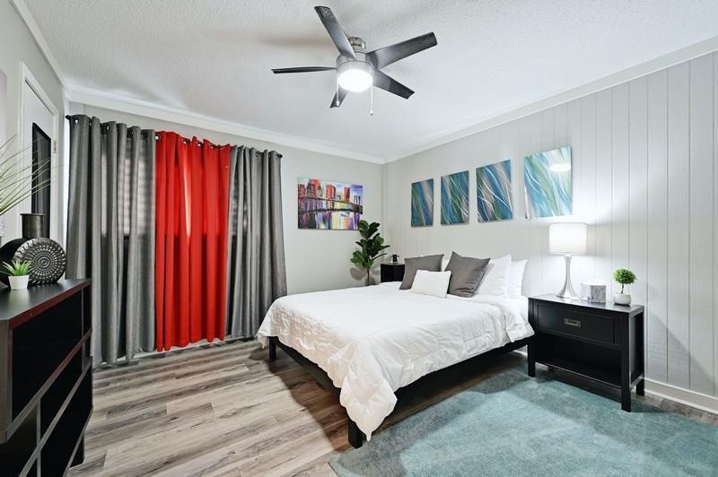 Plank flooring and crown molding accent this comf