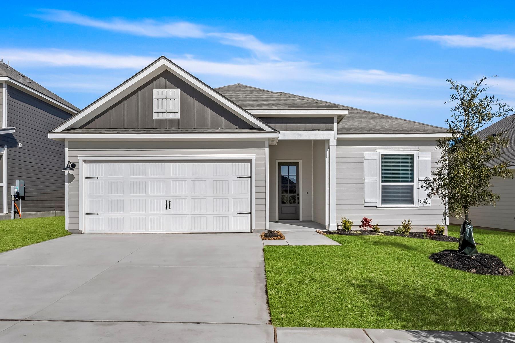 Clean lines and a concrete driveway define this m