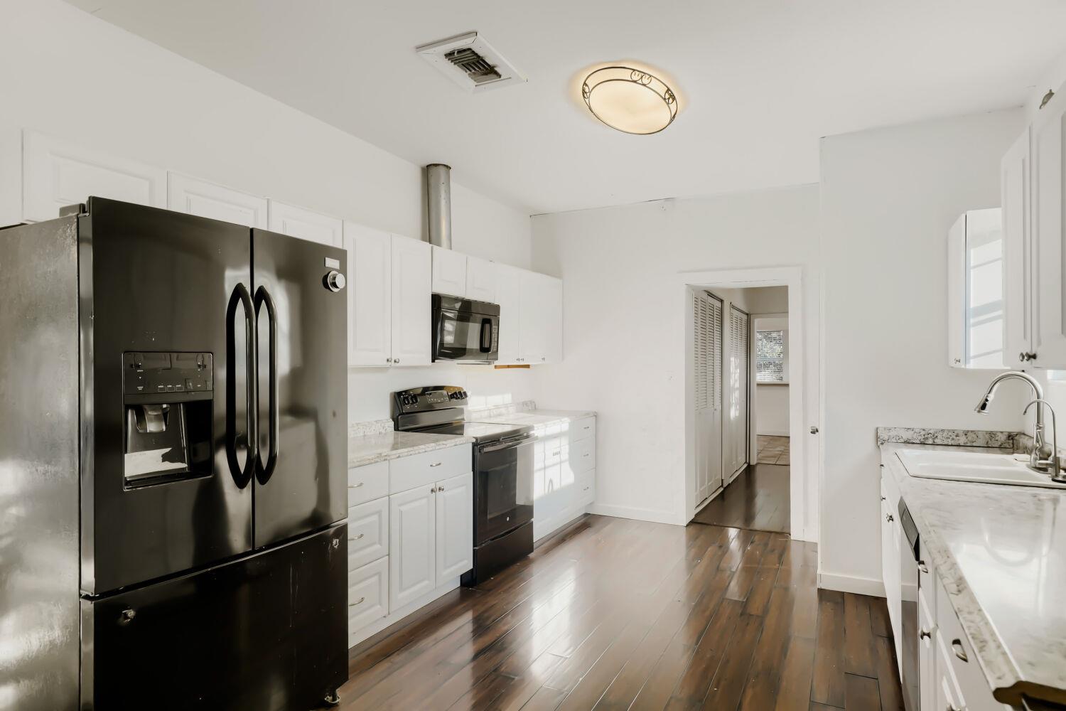 Rich hardwood floors anchor this light-filled kit