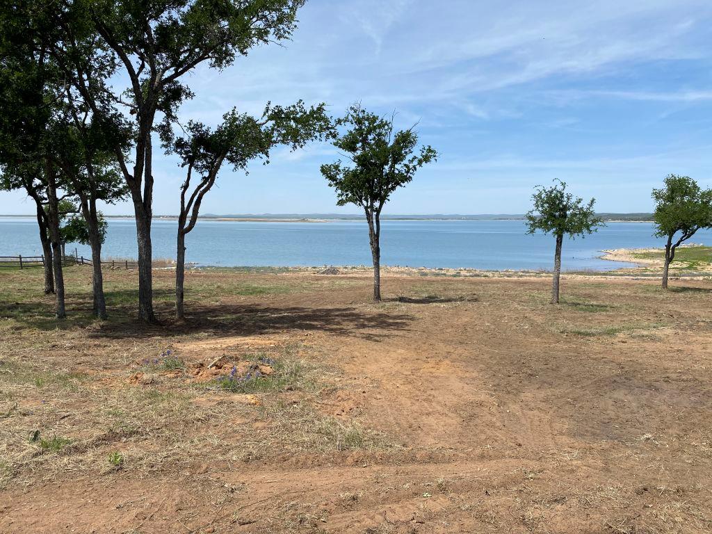 Mature trees frame expansive water views across a