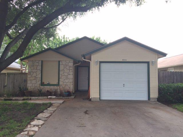 Single story home featuring stone siding, an atta