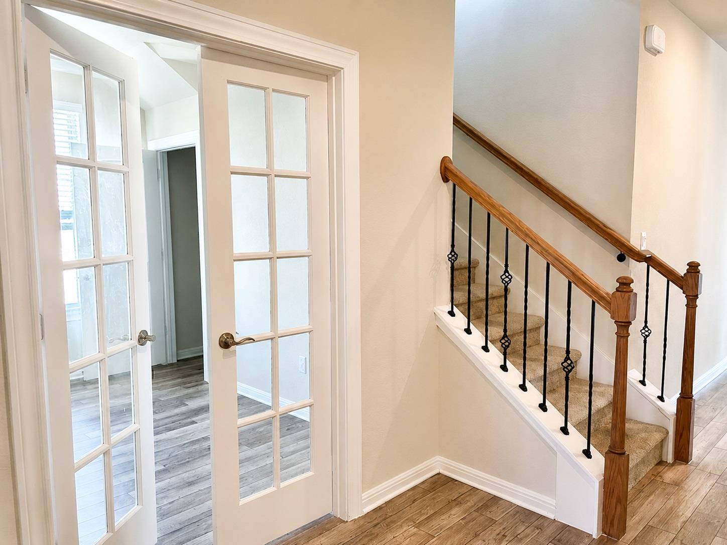 Double French doors open into a versatile room ne