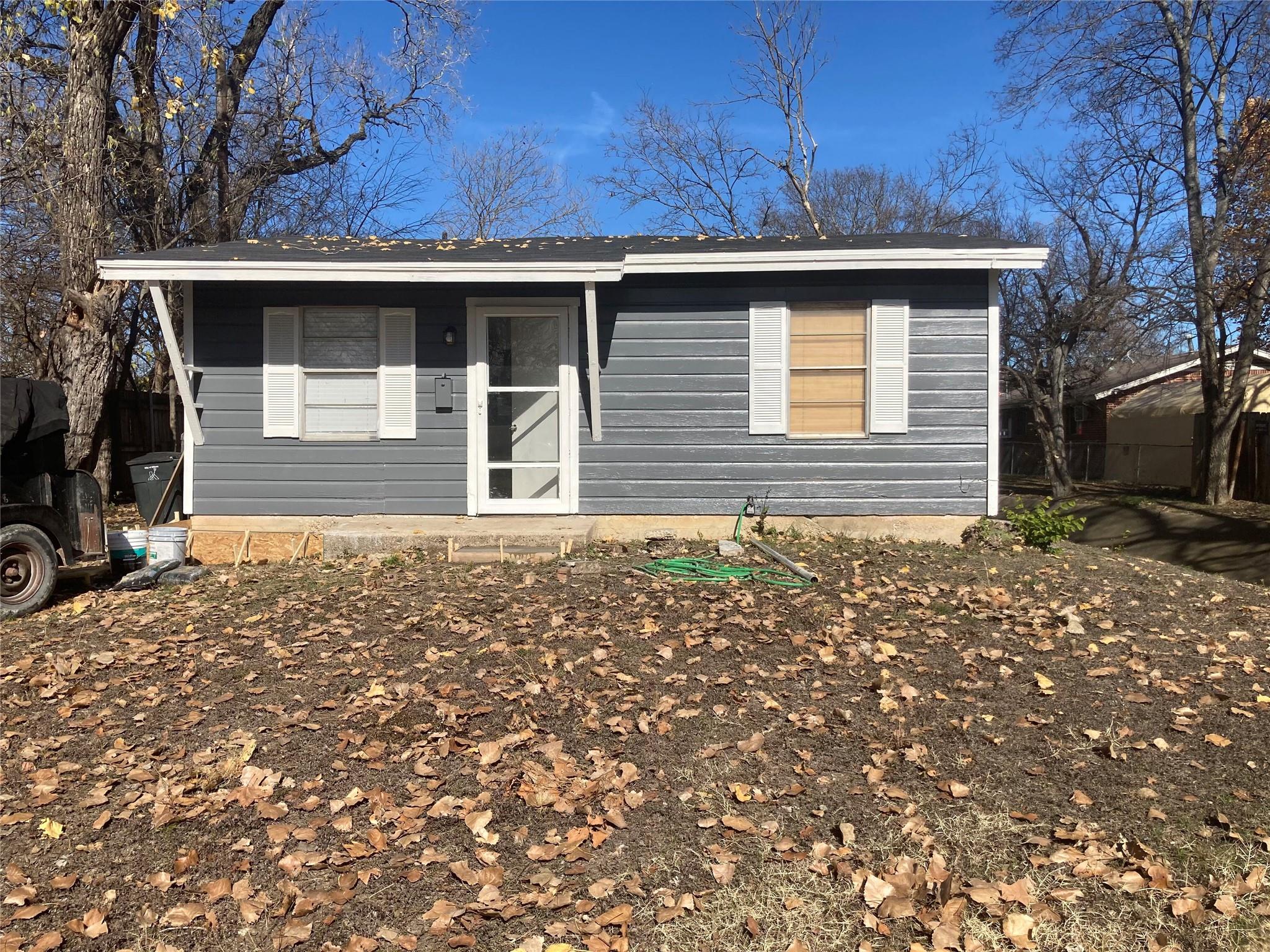 Horizontal siding and classical shutters define t
