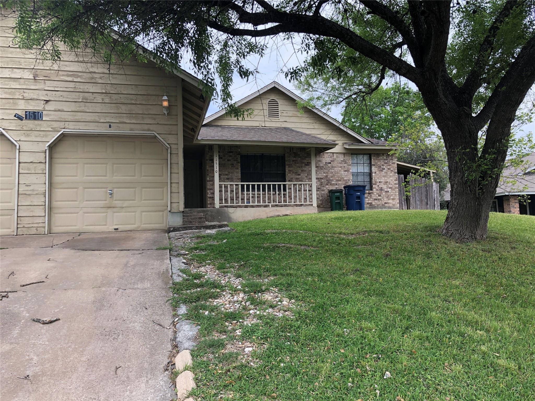 Mature trees shade a welcoming front porch and at