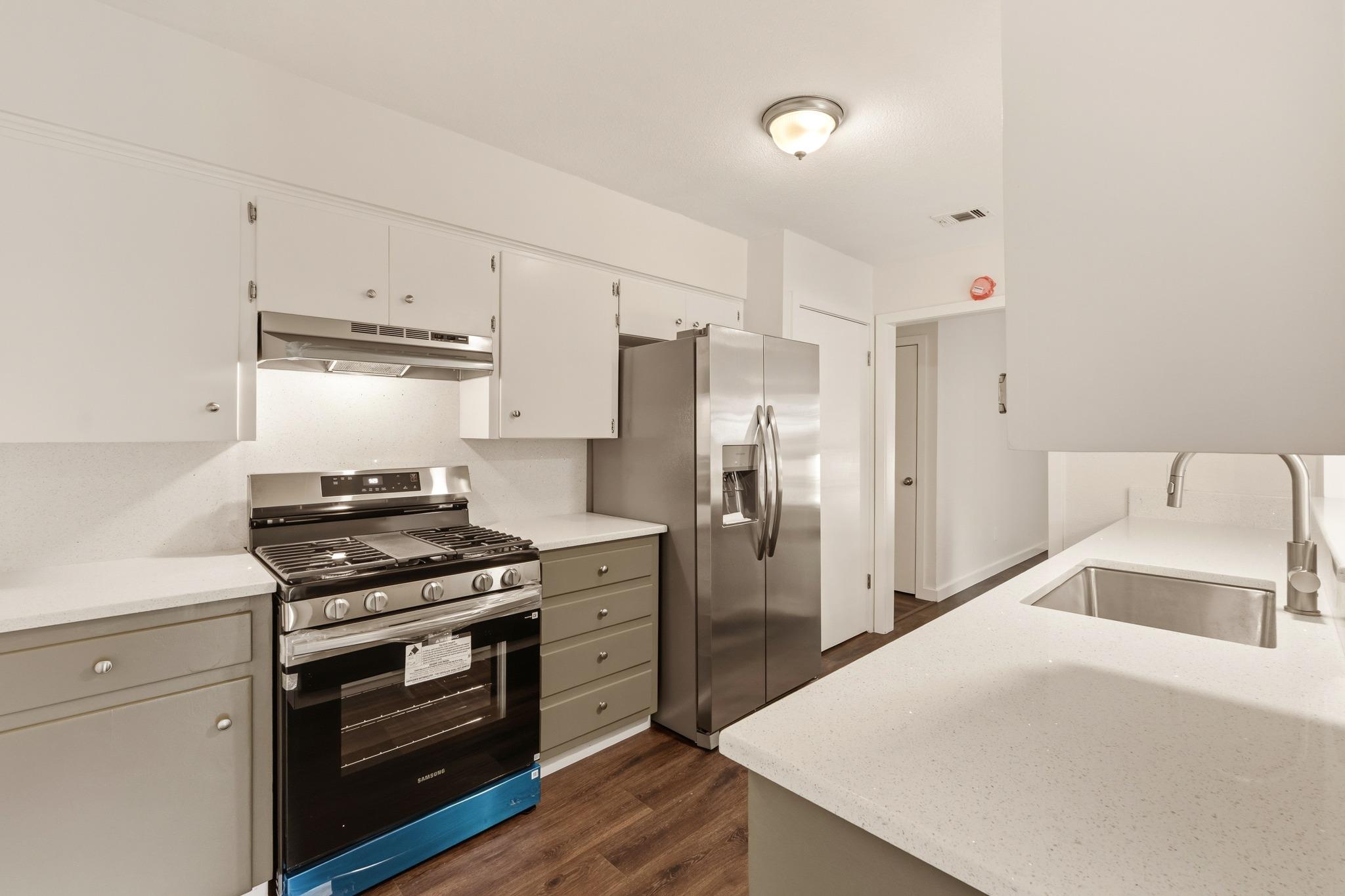 Sleek quartz countertops pair with stainless stee
