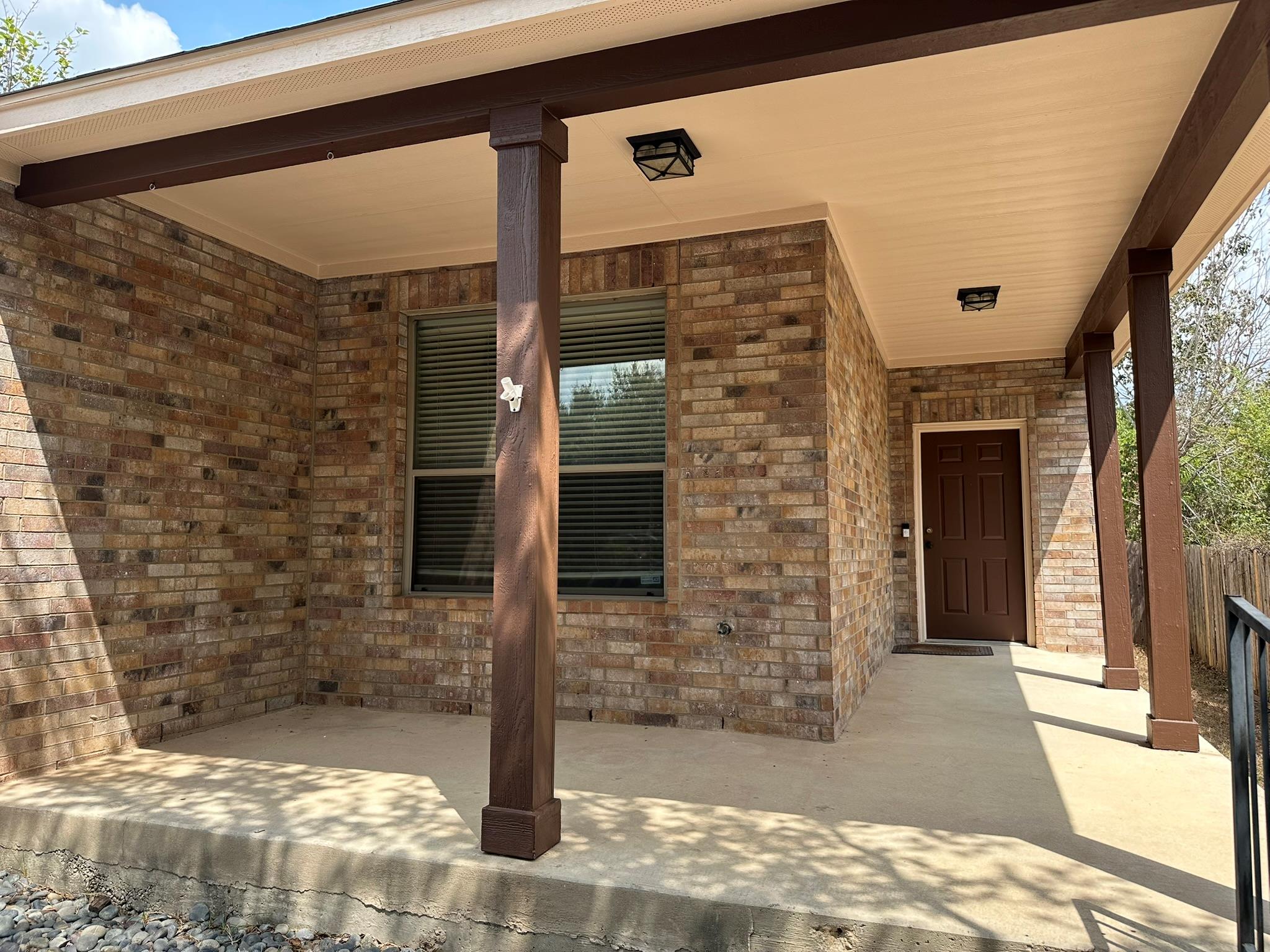 Classic brick accents and a deep covered porch of