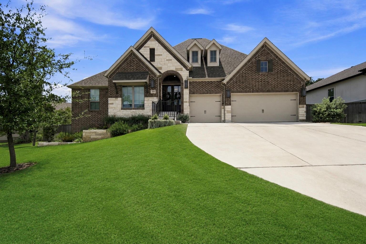 A spacious concrete driveway leads to this classi