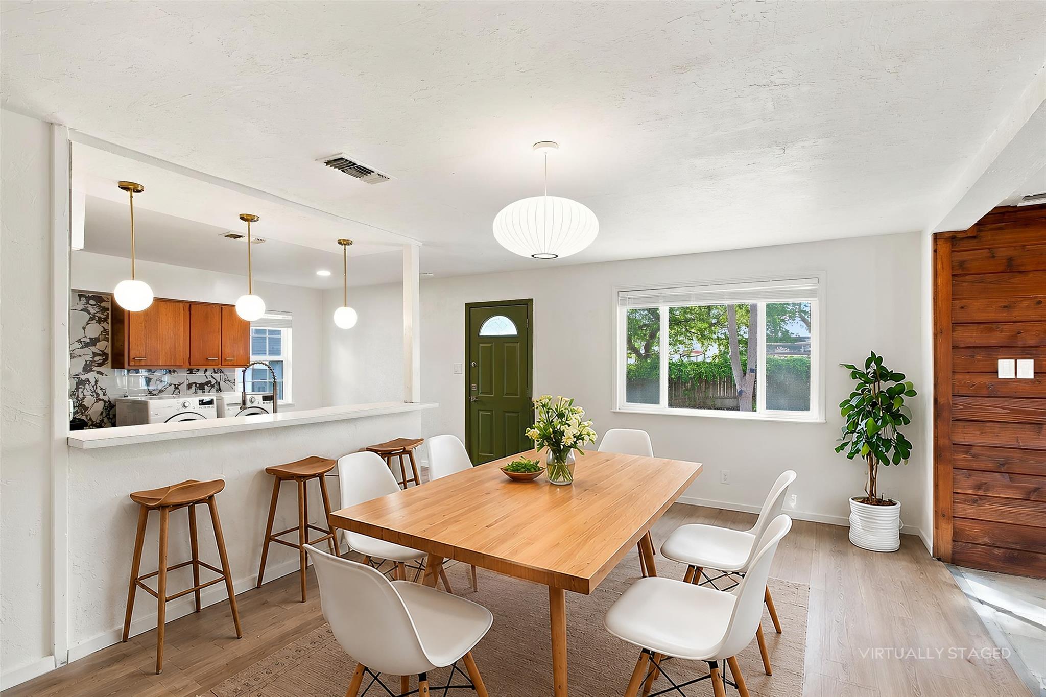 Warm wood flooring and an open pass-through break