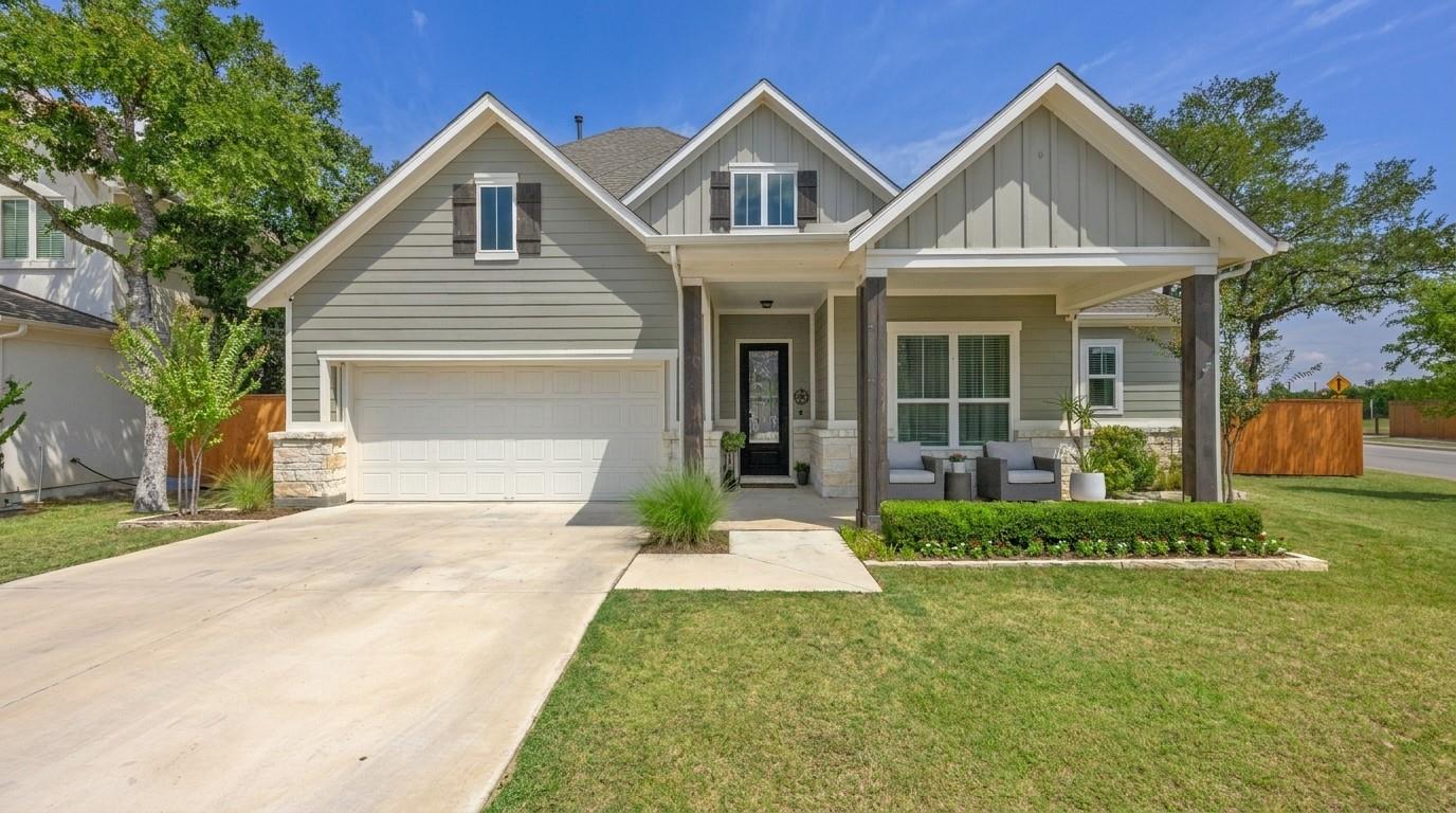 Gabled rooflines and a concrete driveway define t