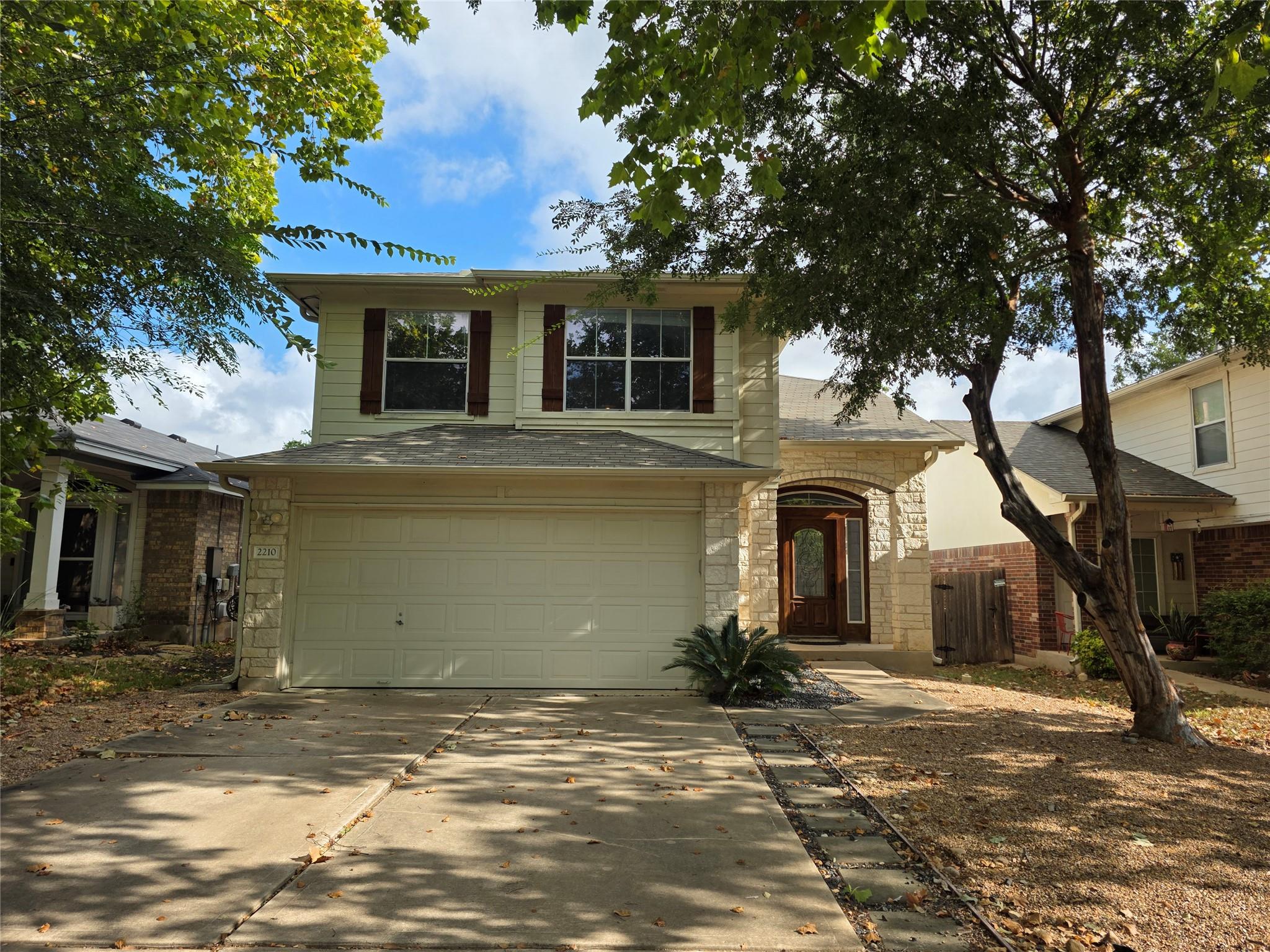 Mature trees frame a welcoming facade complete wi