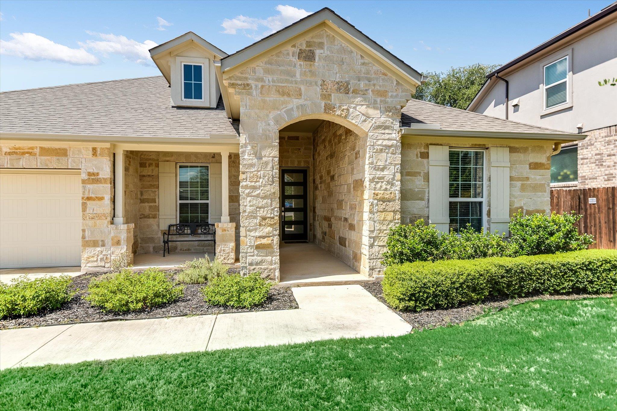 Fine stone masonry and a deep arched entryway def
