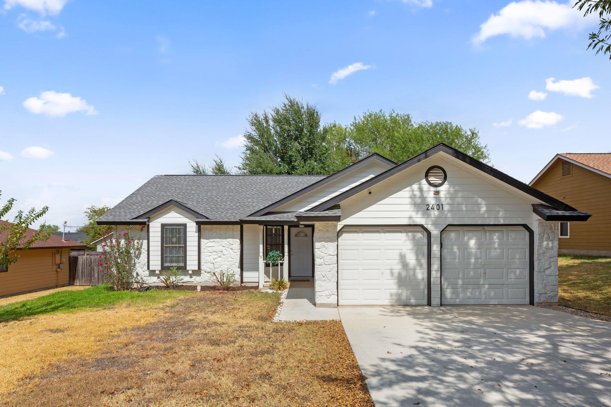 Crisp masonry accents and a double garage define 