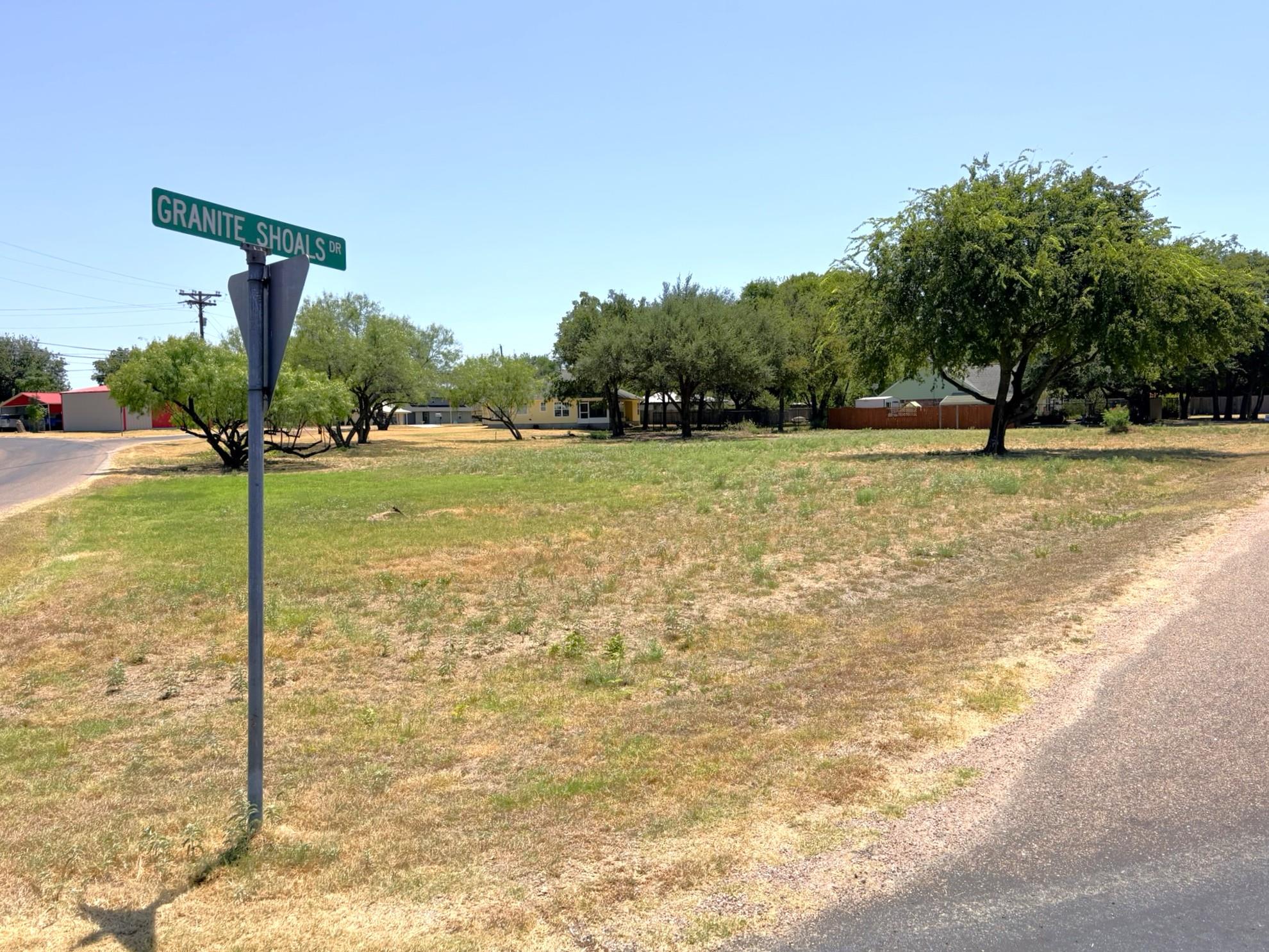 Mature trees dot this level corner lot in an esta