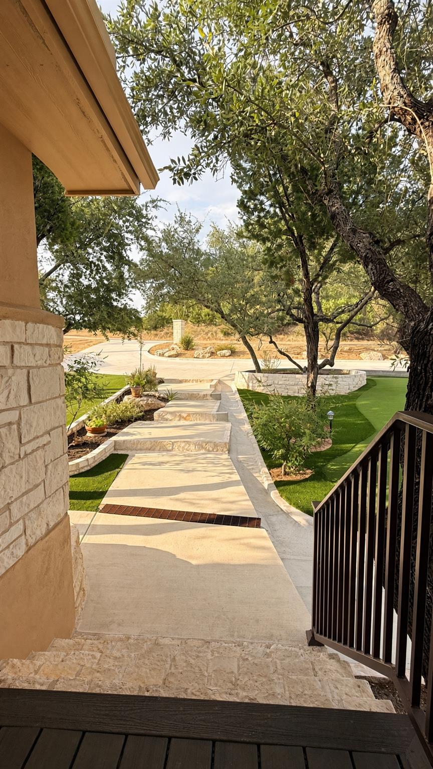 A stone walkway winds through manicured grounds b