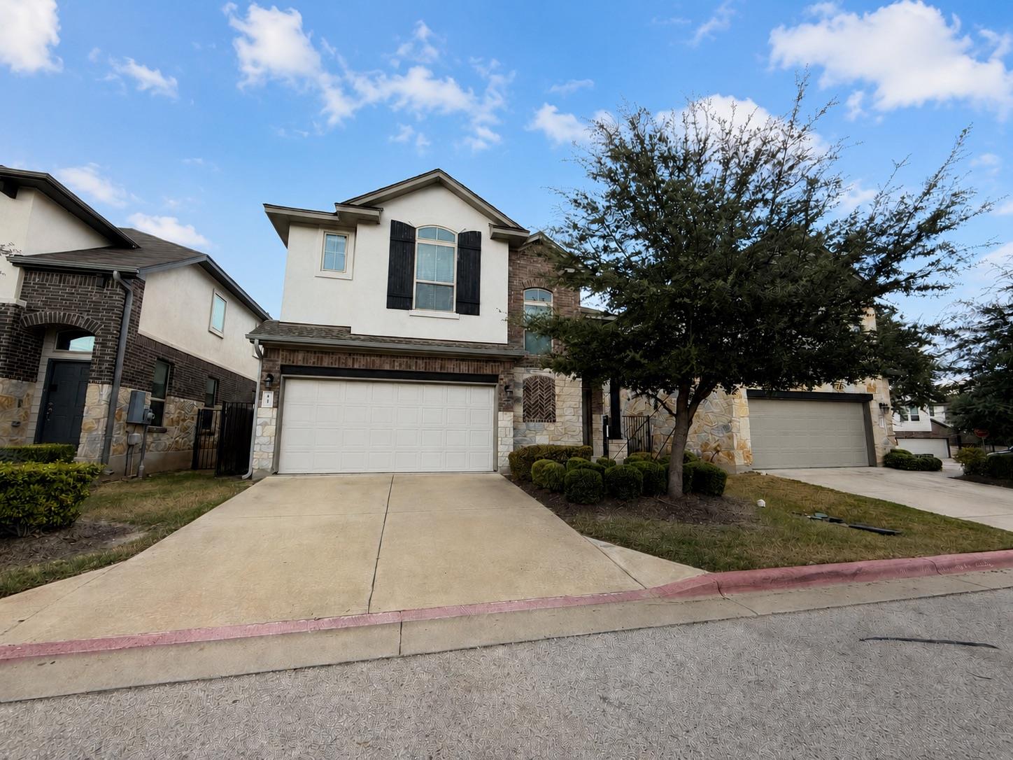 An inviting stone and stucco exterior features a 