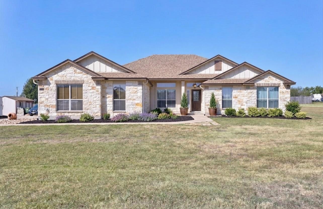 Natural stone masonry and multiple gables define 