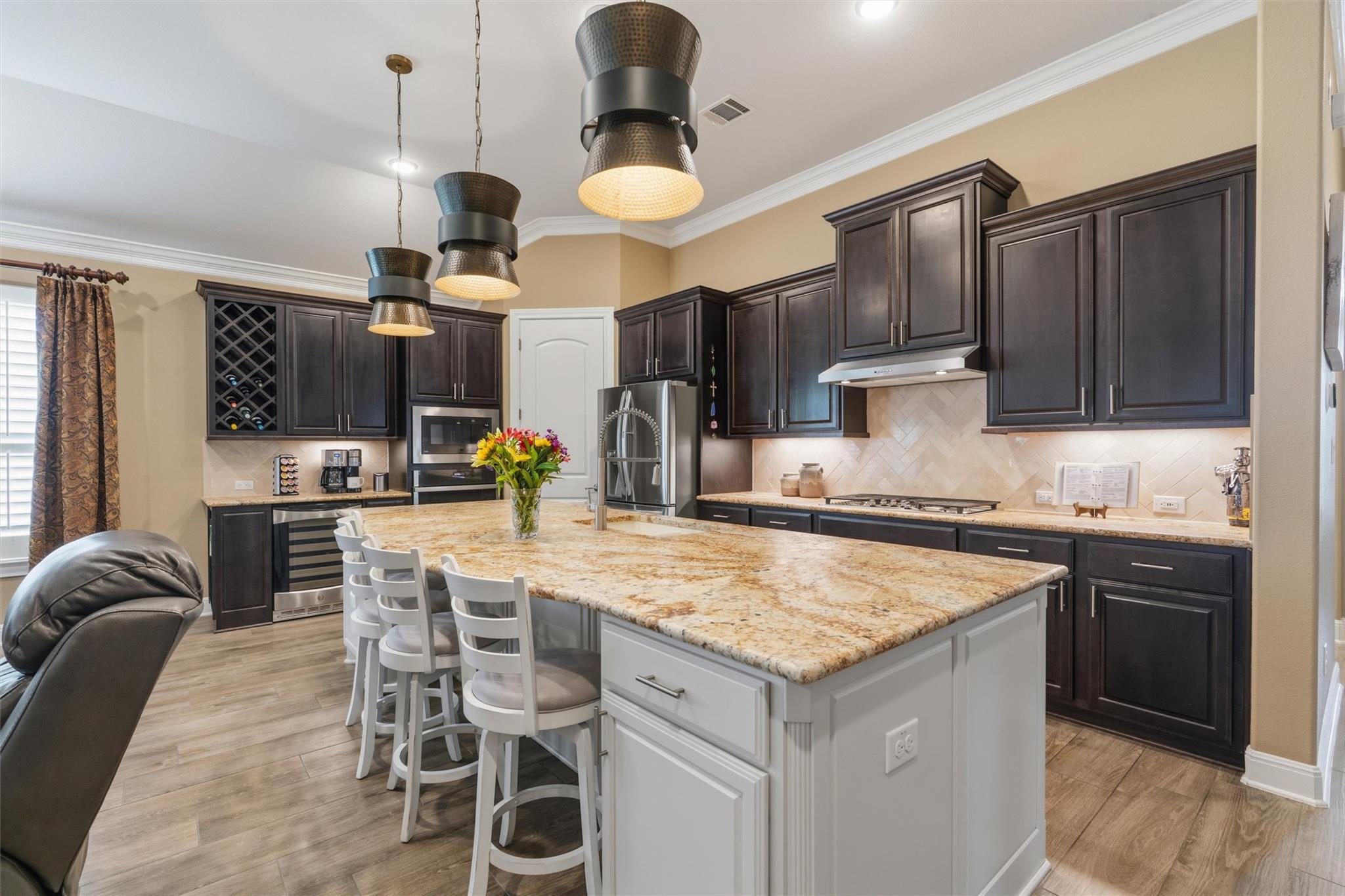 Gleaming granite countertops and dark cabinetry a