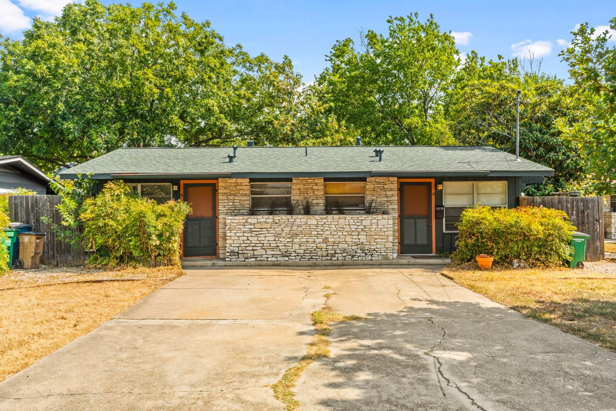 A classic stone facade and wide concrete driveway