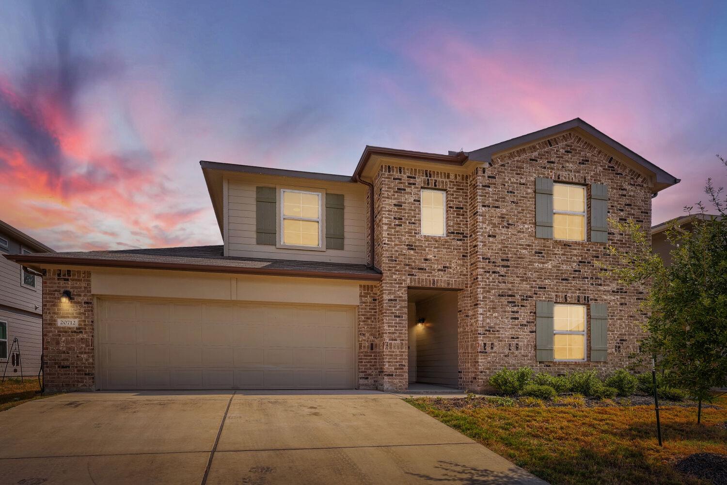 Warm brick construction and a two-car garage crea