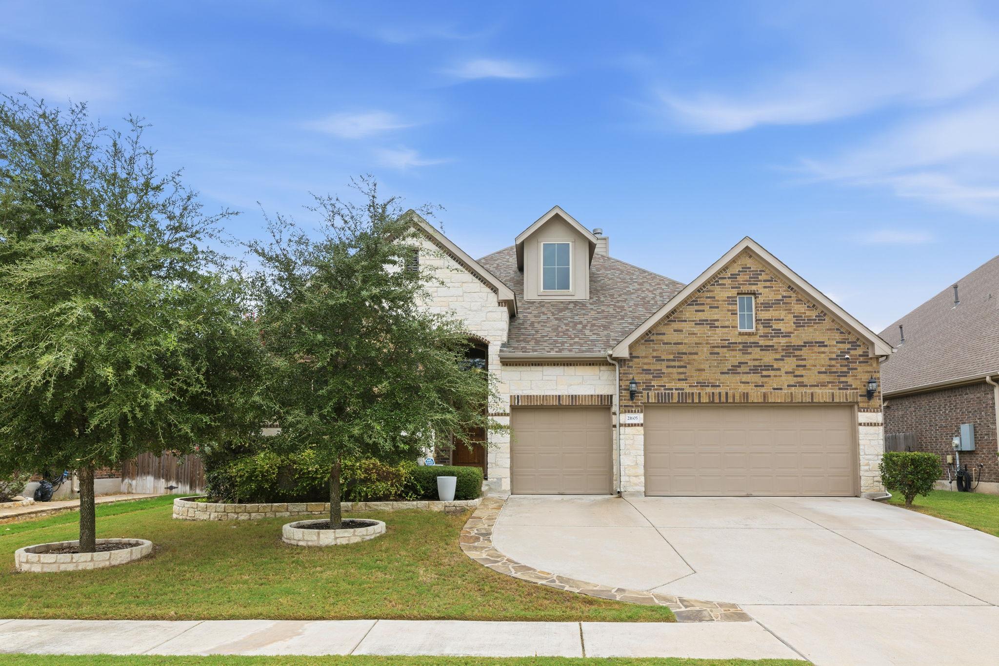 A classic brick and stone facade frames this beau