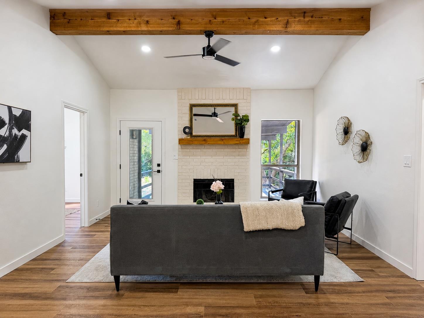 A rustic wooden beam and brick fireplace anchor t