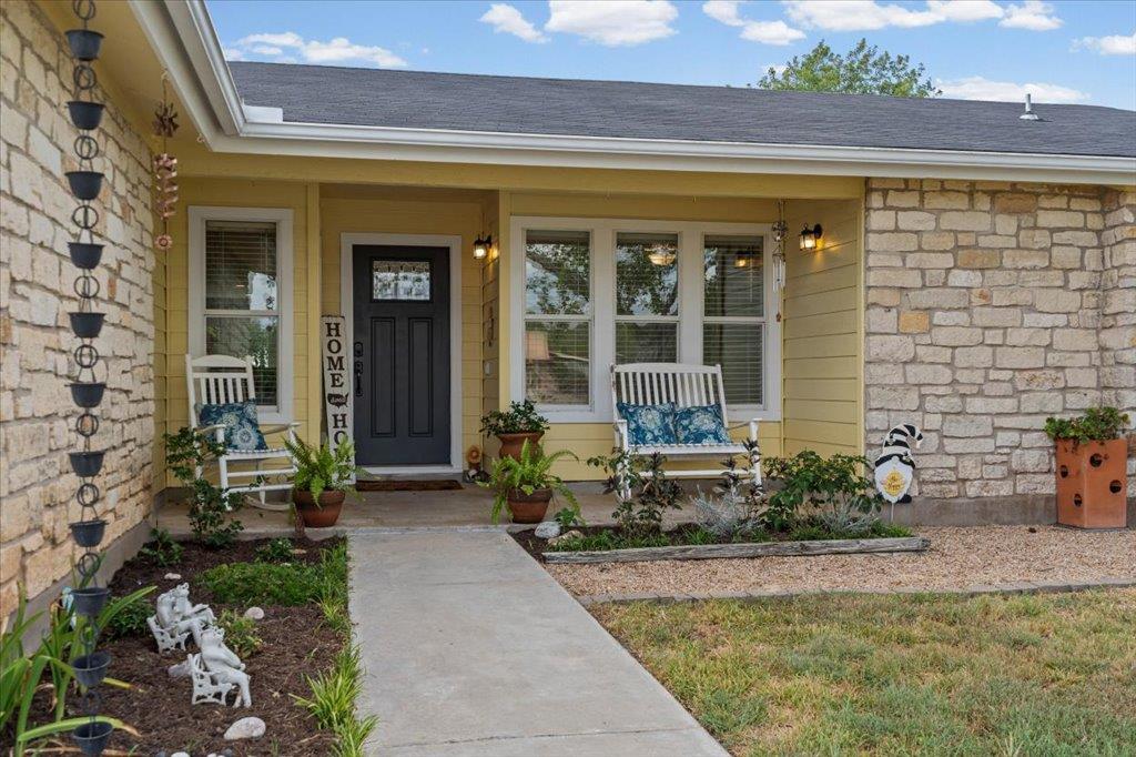 Natural stone accents and a welcoming concrete pa