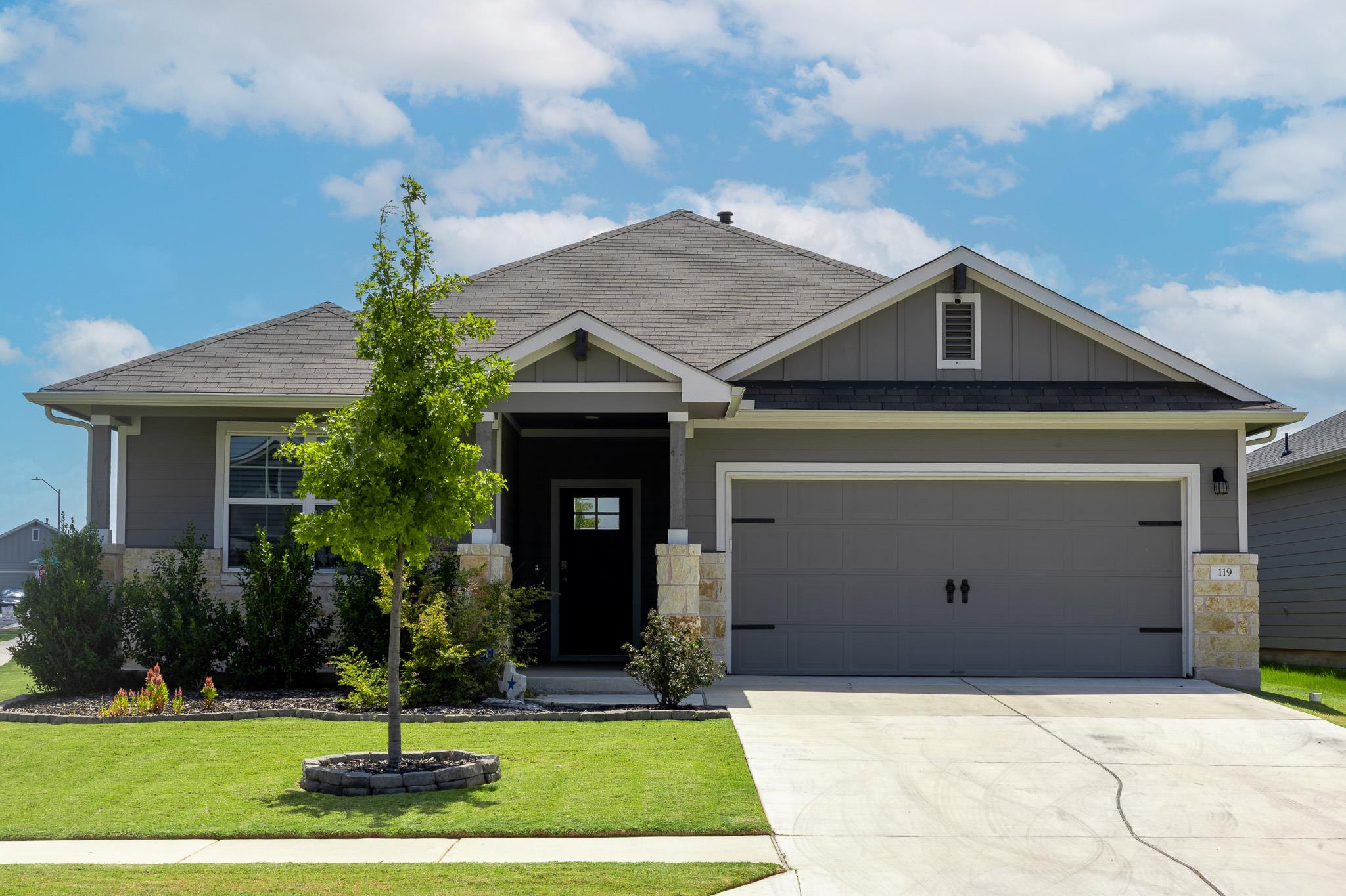 An attractive stone and siding exterior defines t