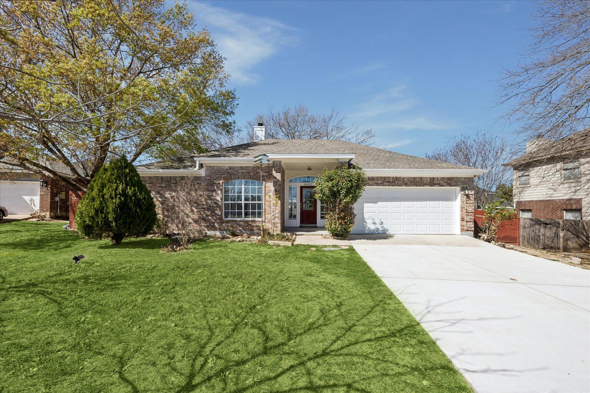 A classic brick exterior and concrete driveway de