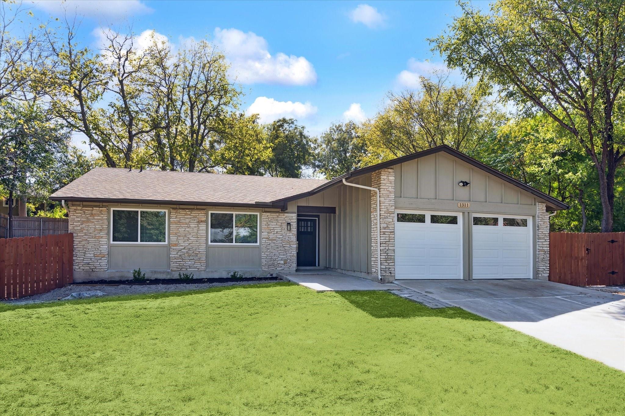 Textured stone veneer accents the exterior facade