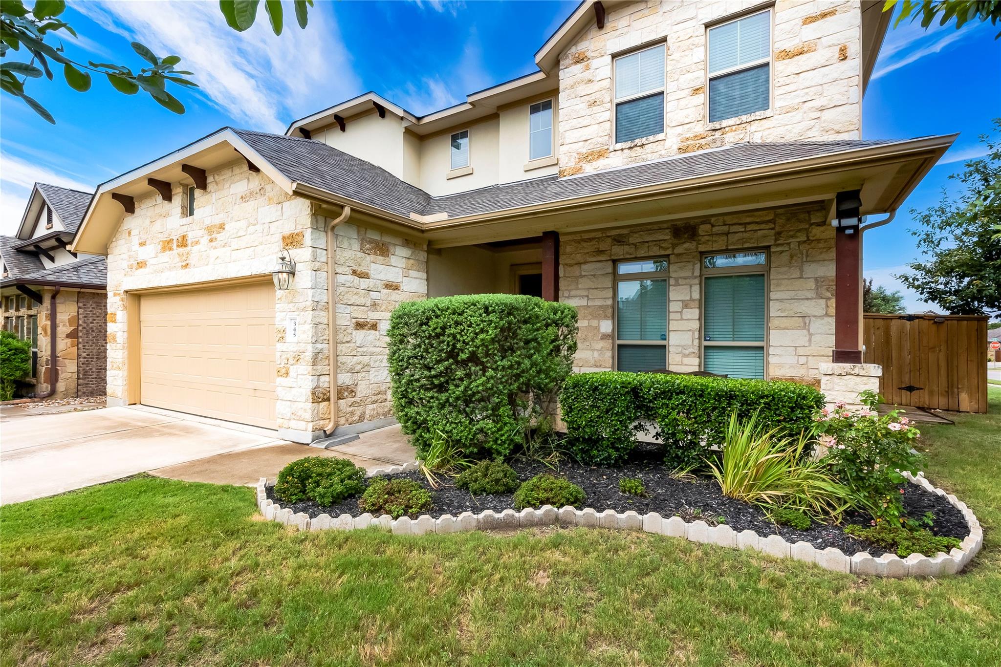 Natural stone and classic stucco siding define th