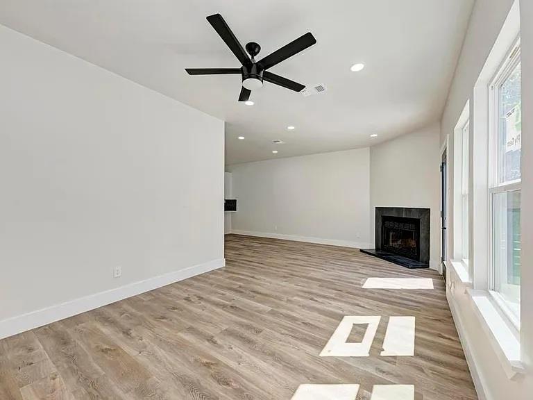 Rich wood-look flooring and a classic corner fire