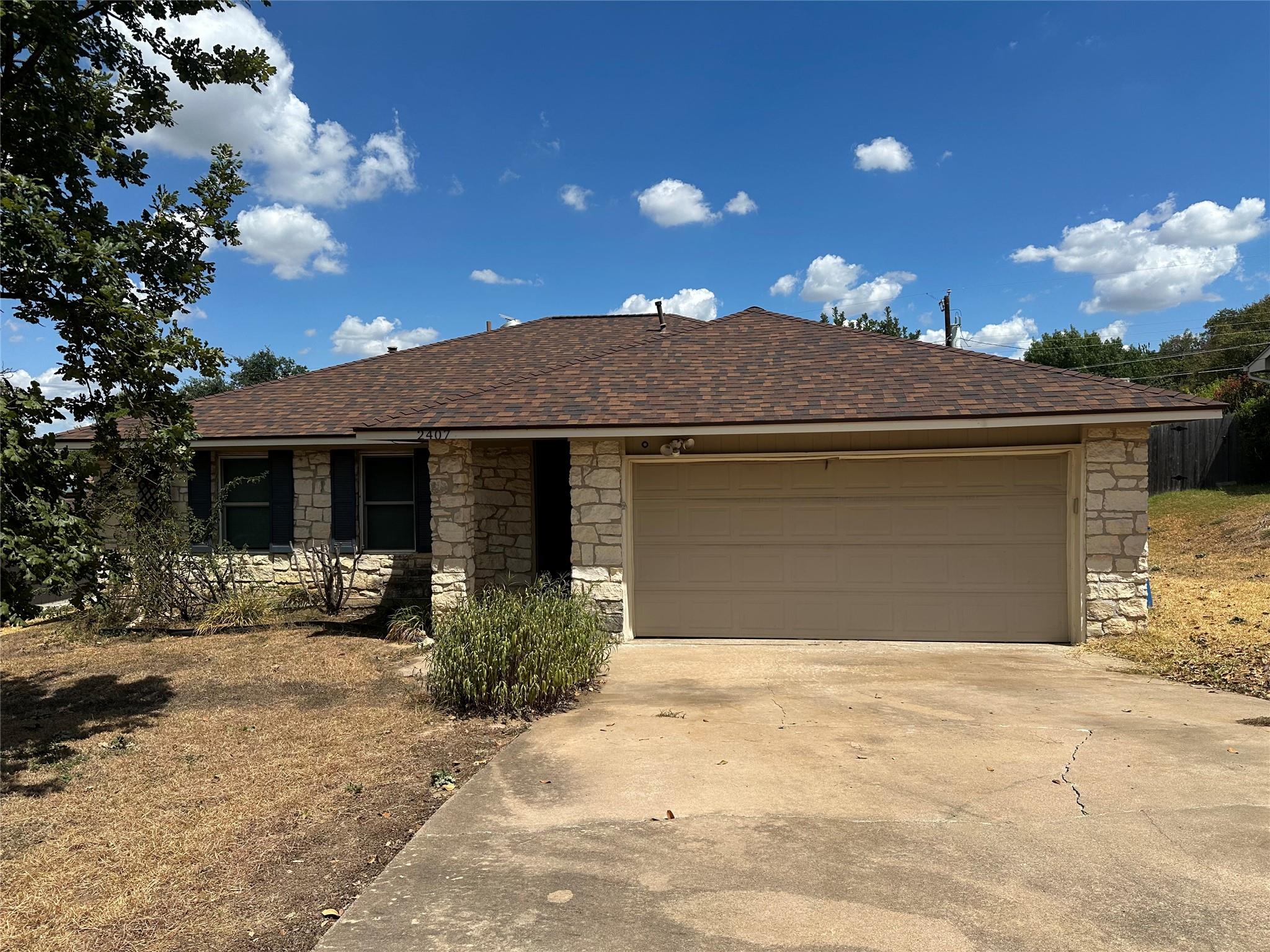 A classic stone exterior and spacious driveway de