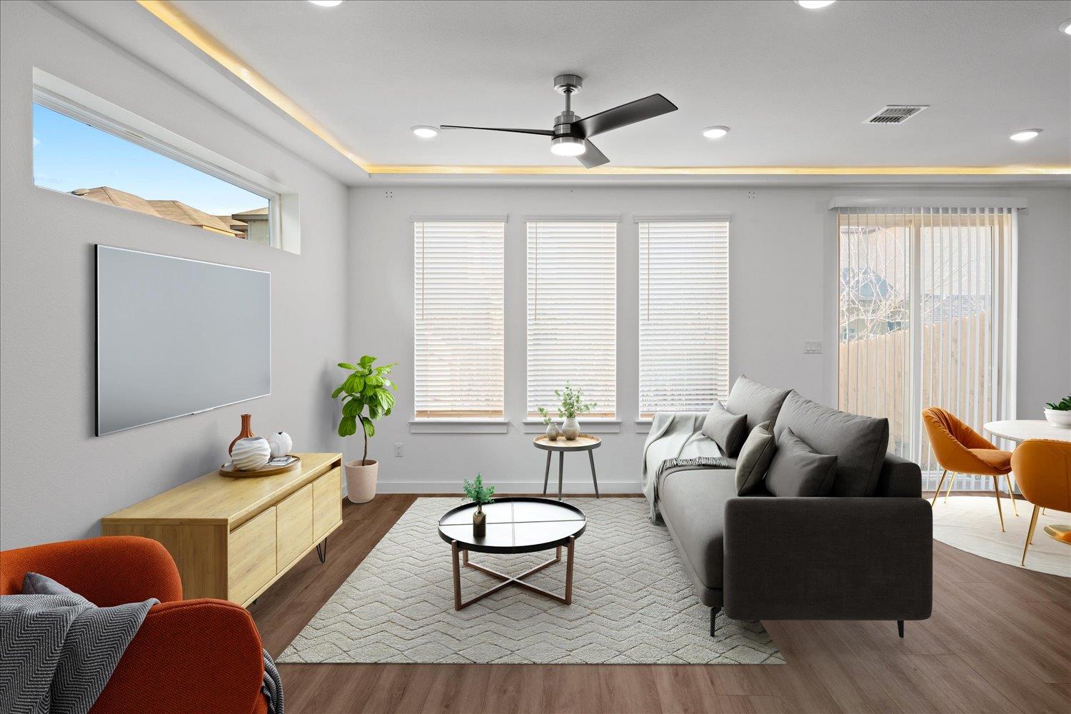 An open living space features wood floors, recess