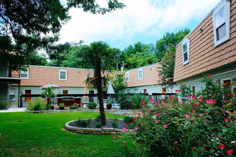 Lush landscaping and a central courtyard surround