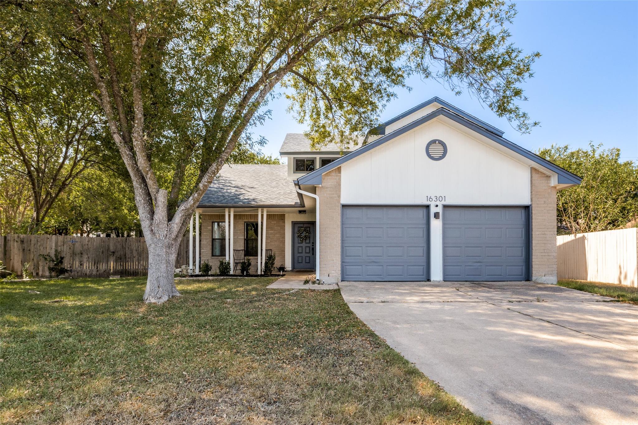 Mature trees shade the front lawn of this multi-l