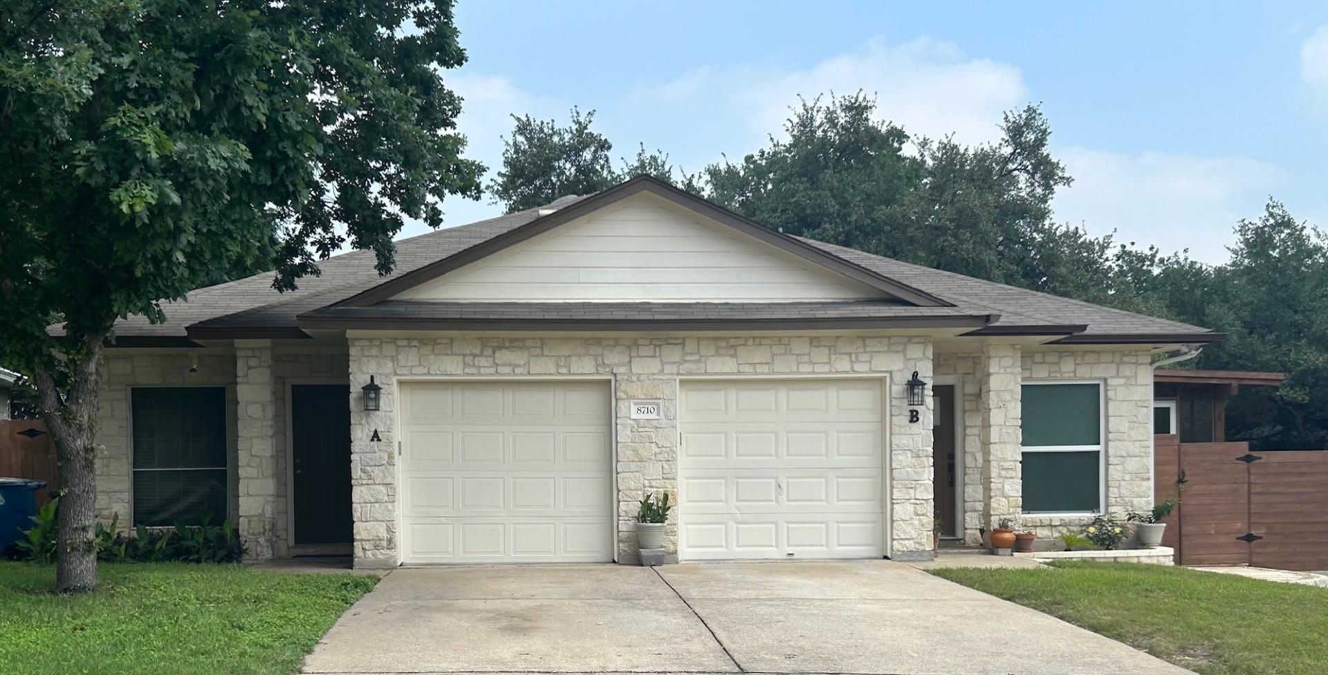 A classic stone exterior paired with a concrete d